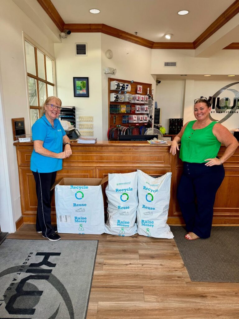 Gym staff at the front desk with full GotSneakers collection bags